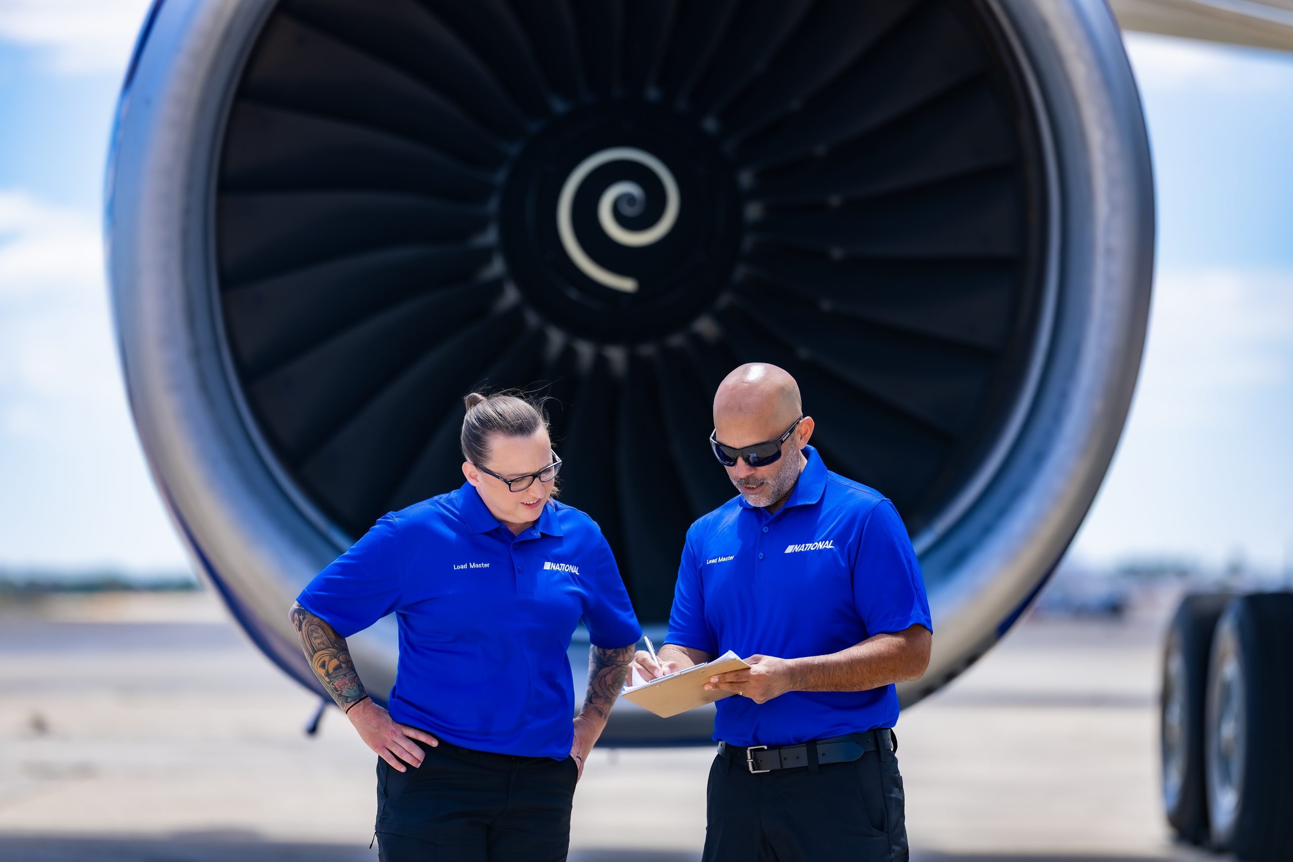 Workers standing beside an airplane