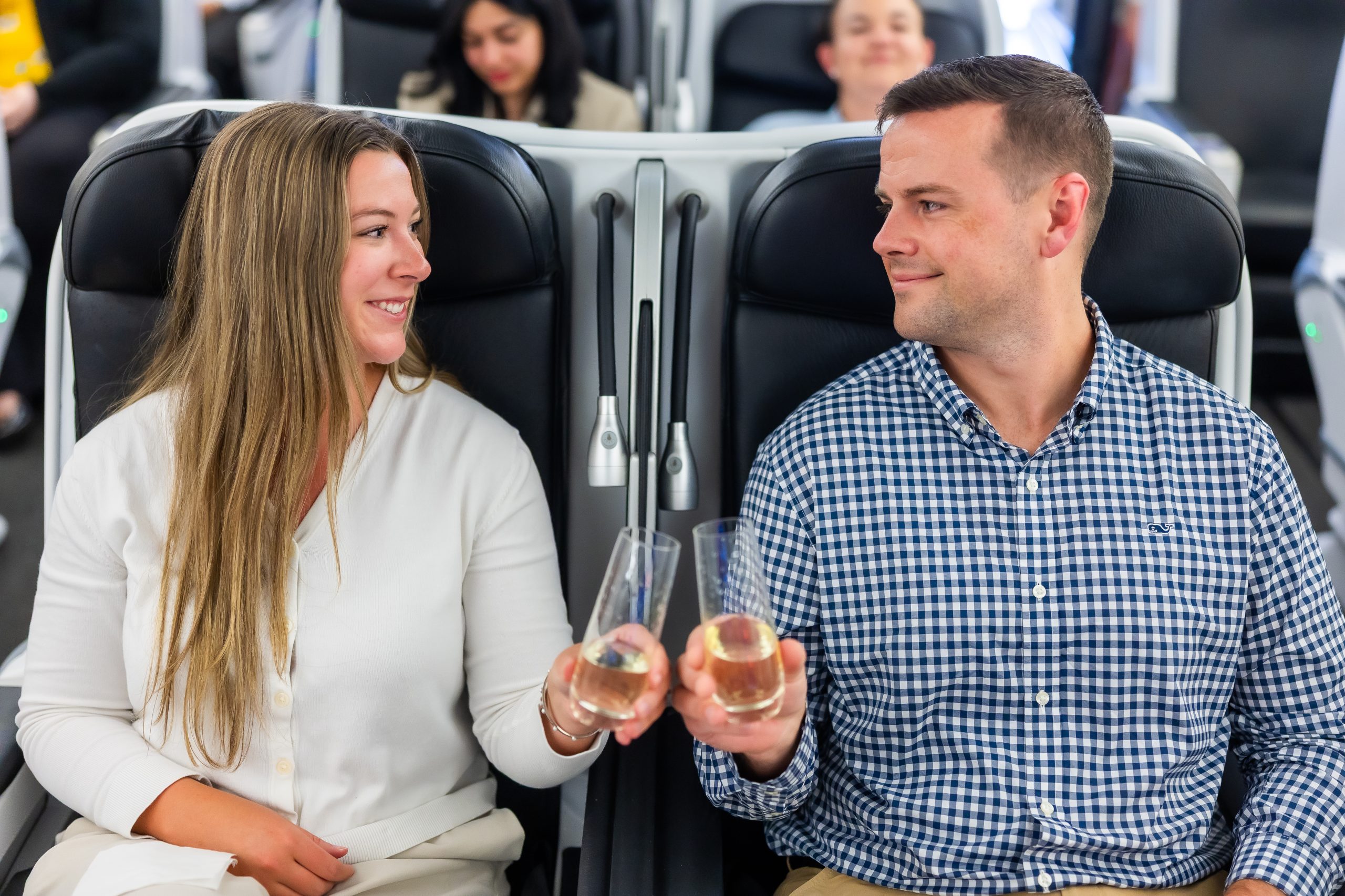 A couple drinking champaign on an airplane