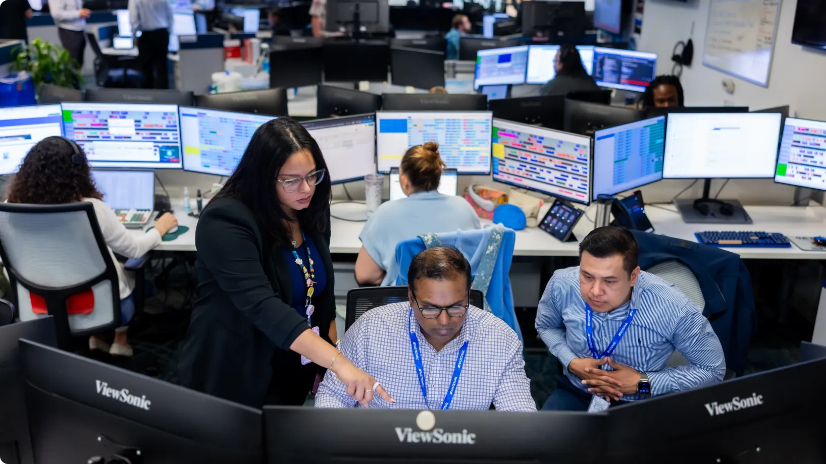 A group of workers monitoring screens