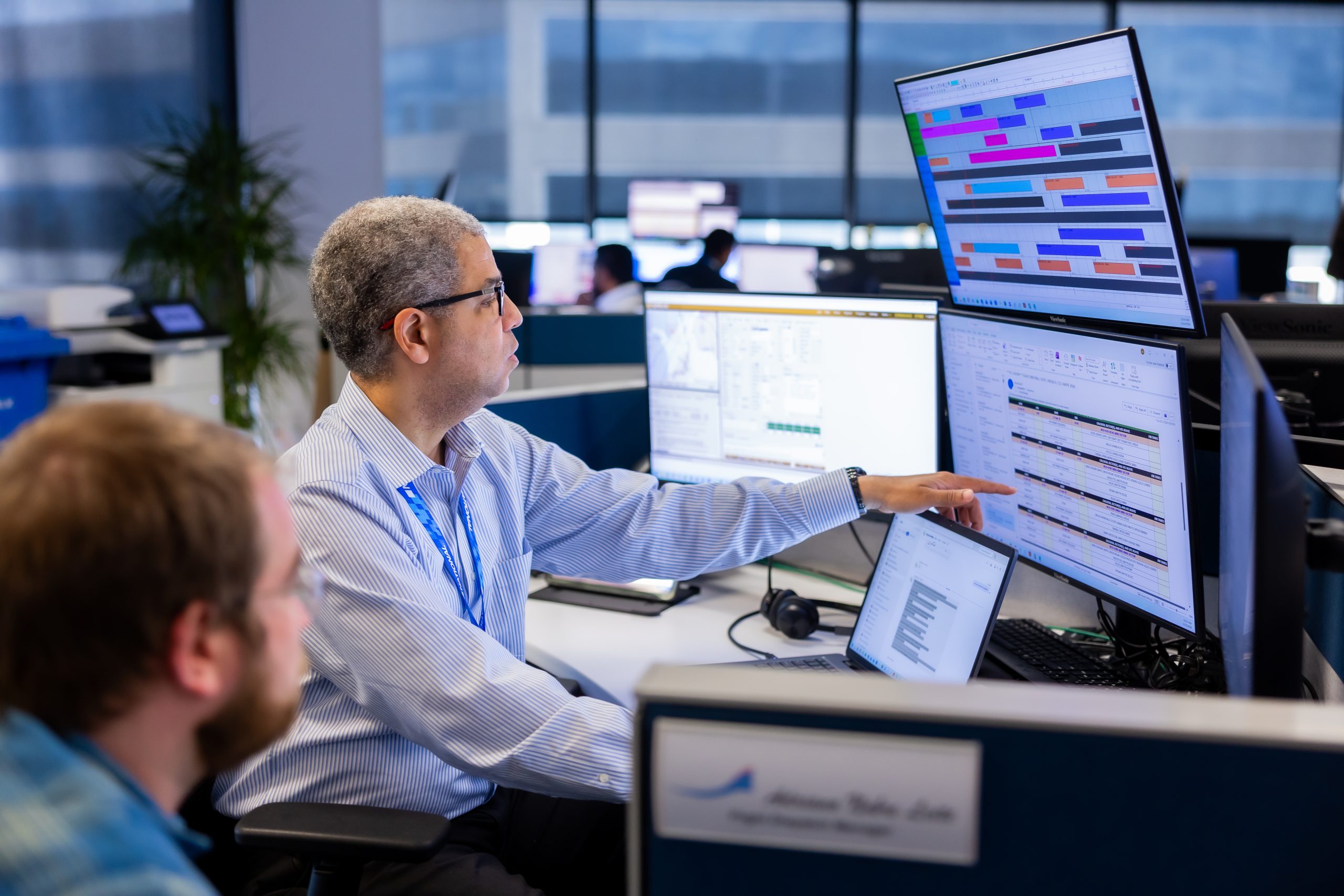 Two people monitoring screens